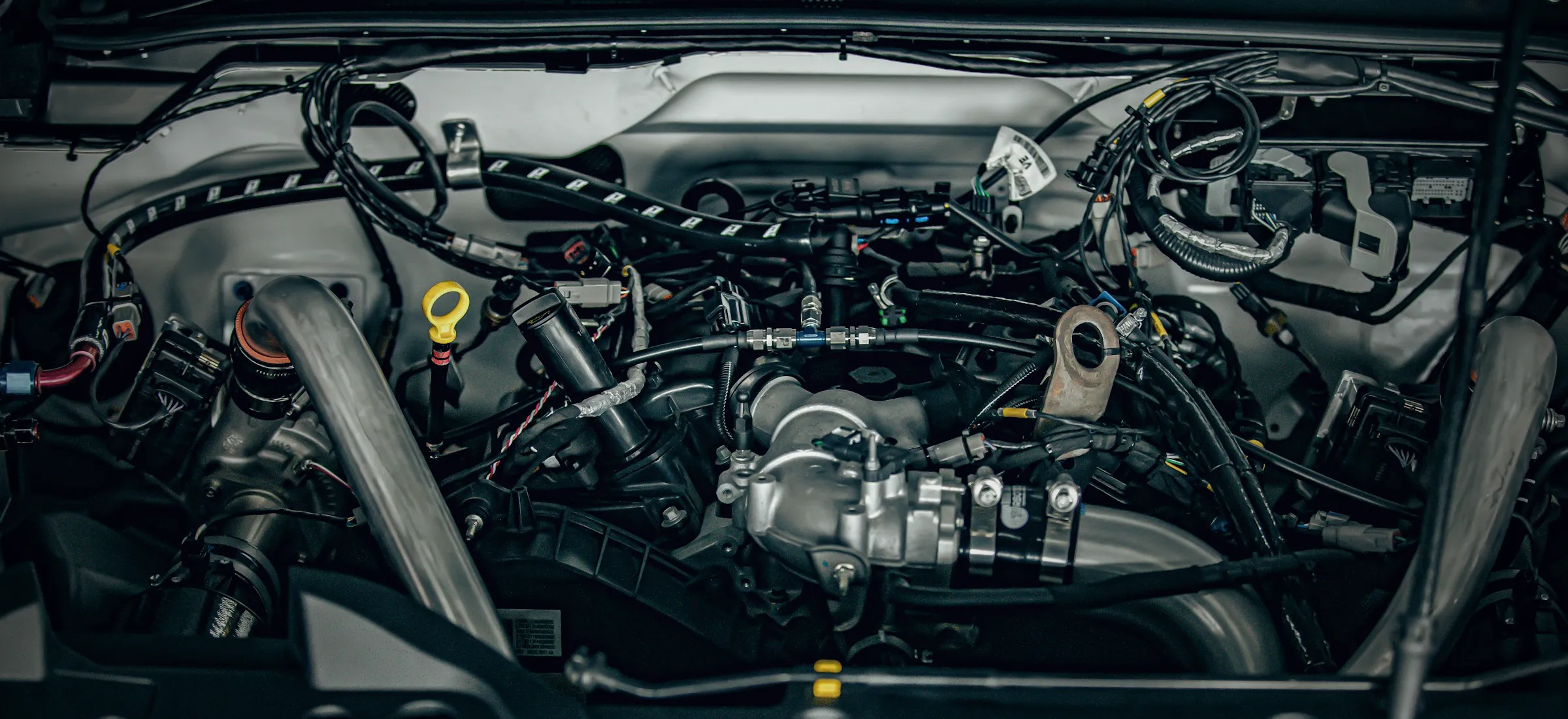 The wiring harness and connectors of a modern engine bay